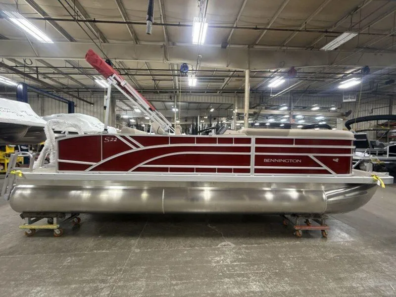 Slide: The Image of 2025 Bennington S Swingback 22 SSB pontoon boat in a factory setting. - 15