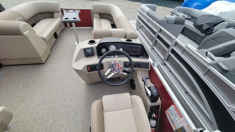 Slide: The Image of 2025 Bennington S Swingback 22 SSB interior with beige seating and modern helm. - 4