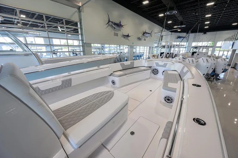 Slide: The Image of 2025 Contender 39 ST boat interior with spacious seating and modern design in a showroom. - 13