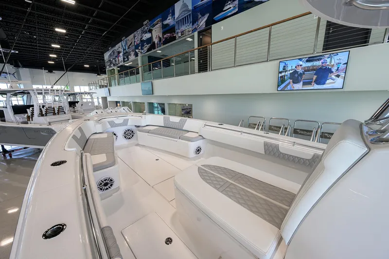 Slide: The Image of 2025 Contender 39 ST boat interior with spacious seating and modern design in showroom. - 16