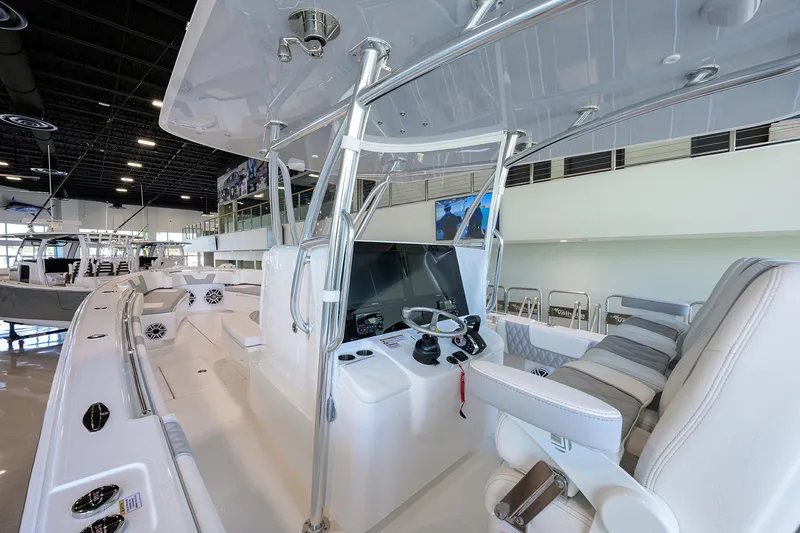 Slide: The Image of 2025 Contender 39 ST boat interior with modern helm and seating in showroom. - 21