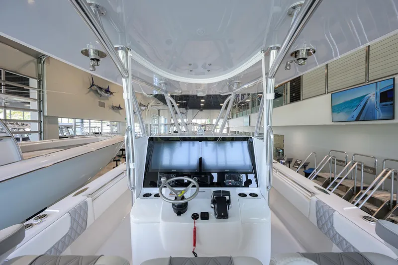 Slide: The Image of 2025 Contender 39 ST boat interior with modern helm in showroom. - 23