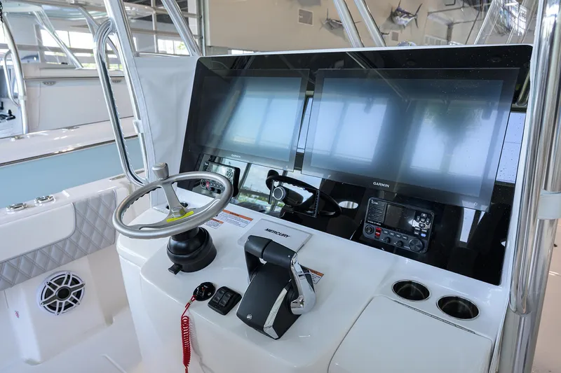 Slide: The Image of 2025 Contender 39 ST boat helm with advanced navigation screens and controls. - 25