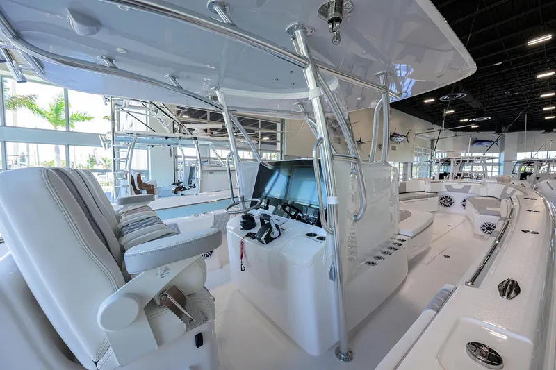 Slide: The Image of 2025 Contender 39 ST boat interior with modern helm and seating in showroom. - 26