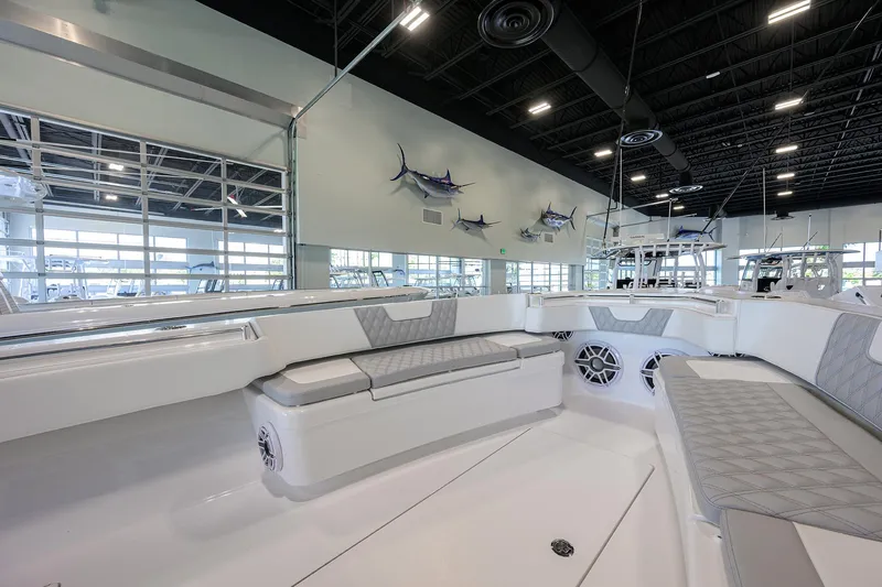 Slide: The Image of 2025 Contender 39 ST boat interior with seating, displayed in a showroom. - 3