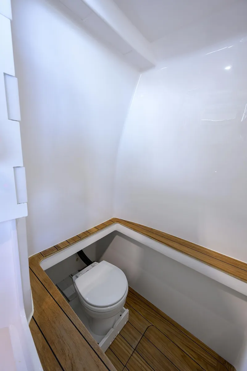 Slide: The Image of 2025 Contender 39 ST boat bathroom with wooden flooring and modern design. - 31