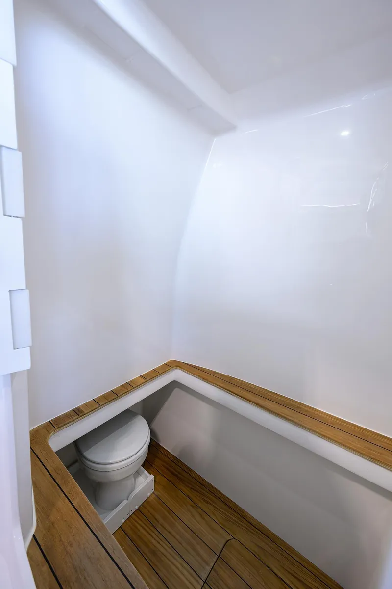 Slide: The Image of 2025 Contender 39 ST boat interior with wooden trim and compact toilet. - 33