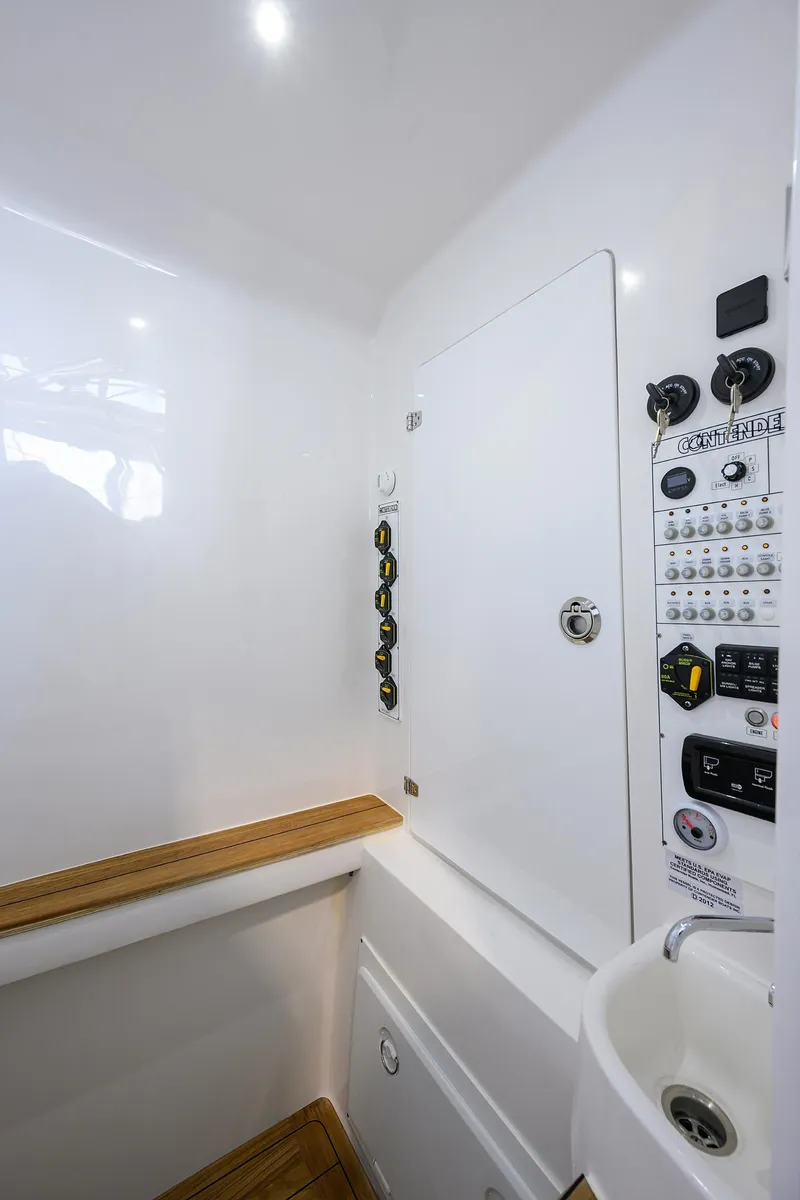Slide: The Image of Interior of 2025 Contender 39 ST boat, featuring control panel and compact sink. - 34