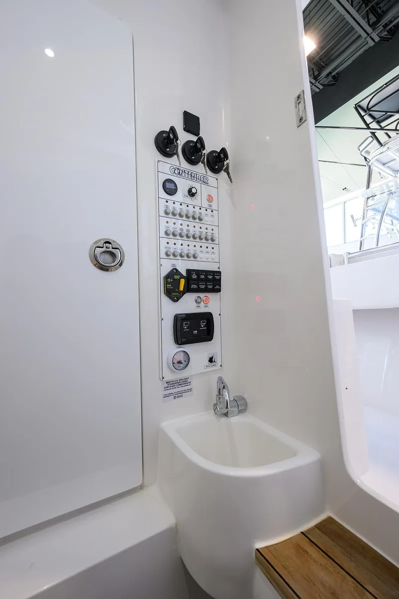 Slide: The Image of 2025 Contender 39 ST boat interior with control panel and seating area. - 36