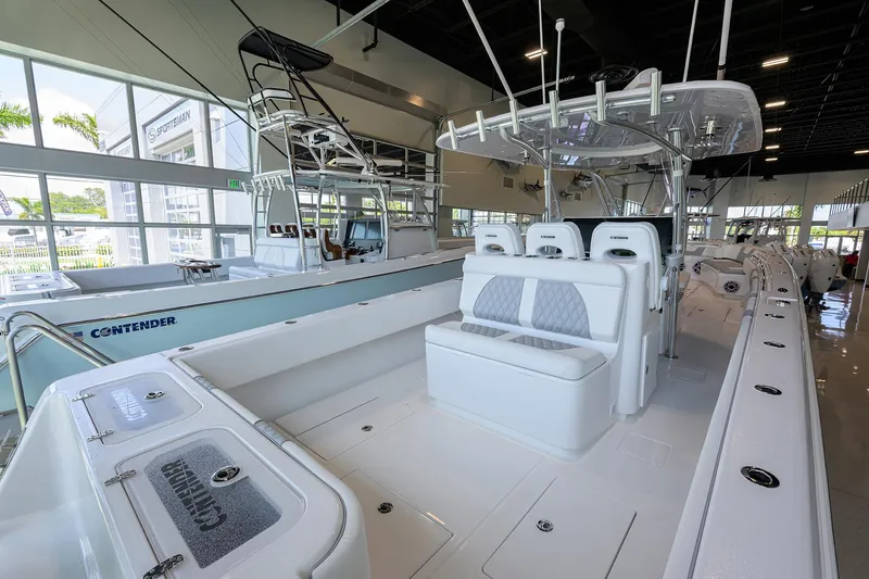 Slide: The Image of 2025 Contender 39 ST boat interior, featuring sleek seating and modern design in a showroom setting. - 38