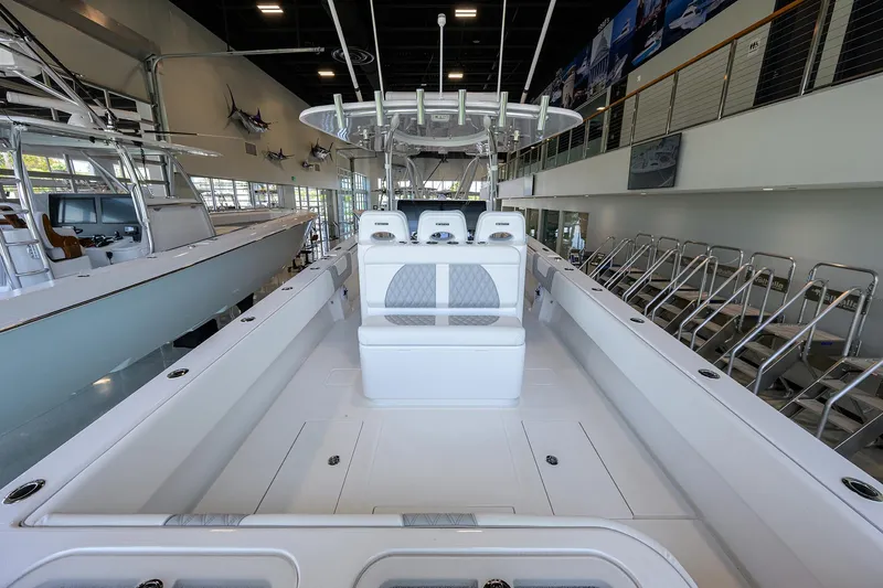 Slide: The Image of 2025 Contender 39 ST boat interior in showroom, featuring sleek seating and modern design. - 39