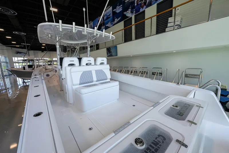 Slide: The Image of 2025 Contender 39 ST boat interior with seating and storage, displayed in a showroom. - 41