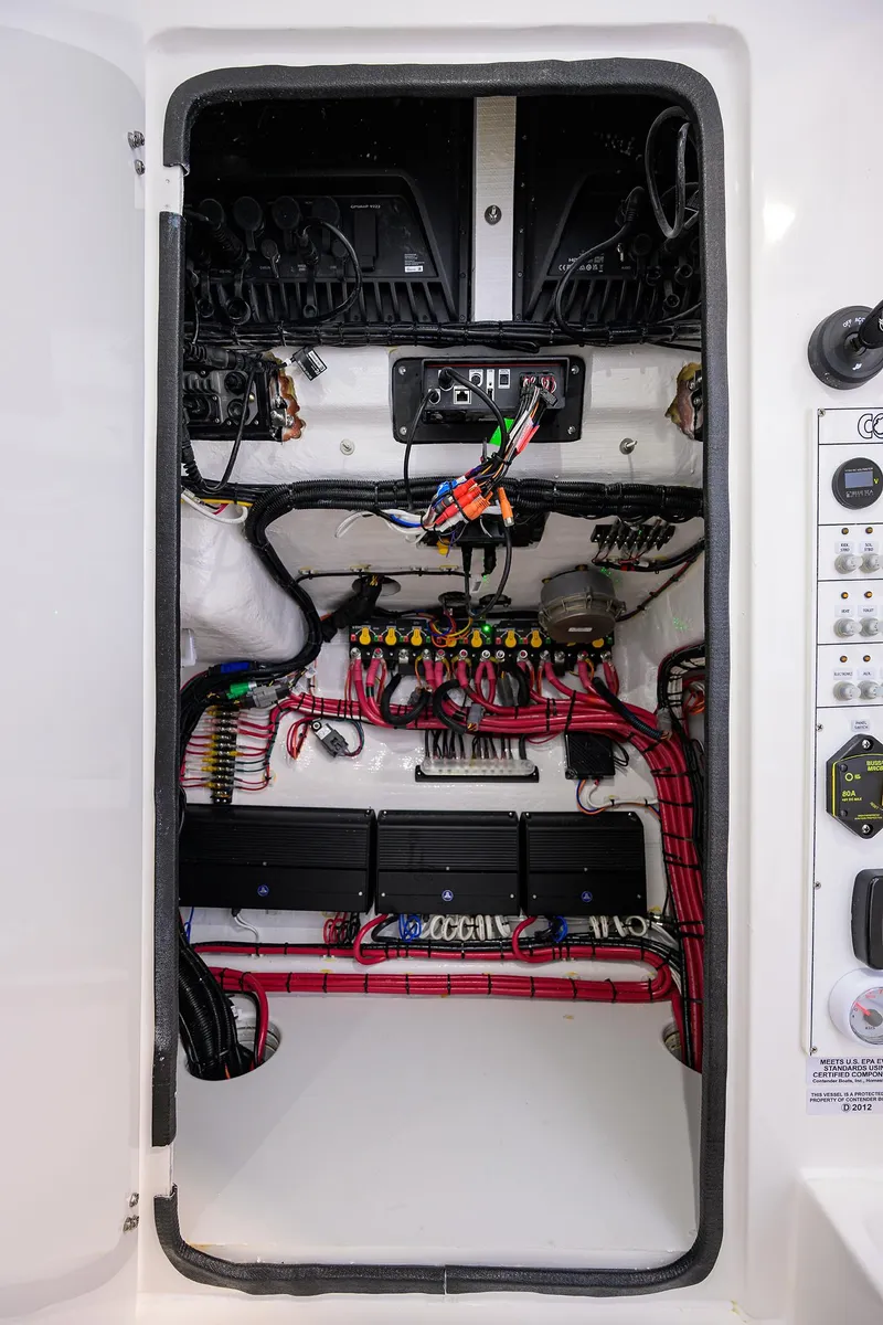 Slide: The Image of Electrical panel of 2025 Contender 39 ST boat with organized wiring and components. - 47