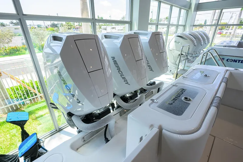Slide: The Image of 2025 Contender 39 ST boat with Mercury outboard engines in showroom. - 49