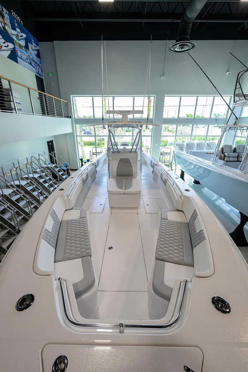 Slide: The Image of 2025 Contender 39 ST boat in showroom, sleek design, spacious deck, modern features. - 5