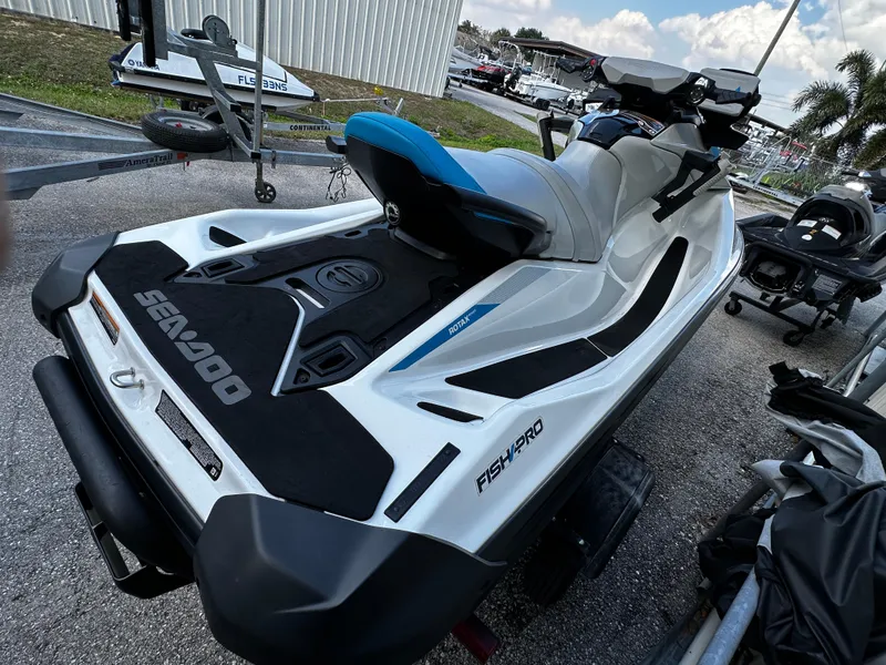 Slide: The Image of 2023 Sea-Doo Fish Pro Scout jet ski, parked outdoors, showcasing sleek design and features. - 6
