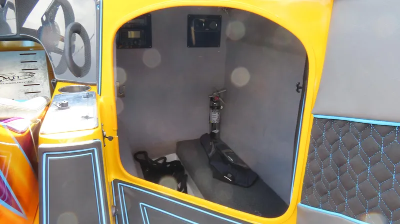 Slide: The Image of Interior of a 2010 MTI 48 R/P boat, featuring a small cabin with seating and safety equipment. - 10