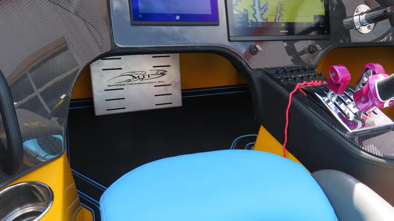 Slide: The Image of Cockpit of 2010 MTI 48 R/P boat with blue seat and control panel. - 16