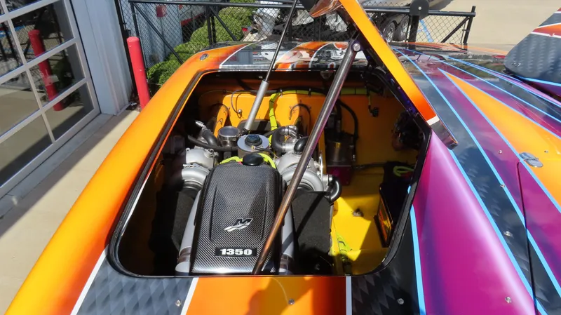 Slide: The Image of 2010 MTI 48 R/P boat engine compartment with vibrant orange and purple exterior. - 19