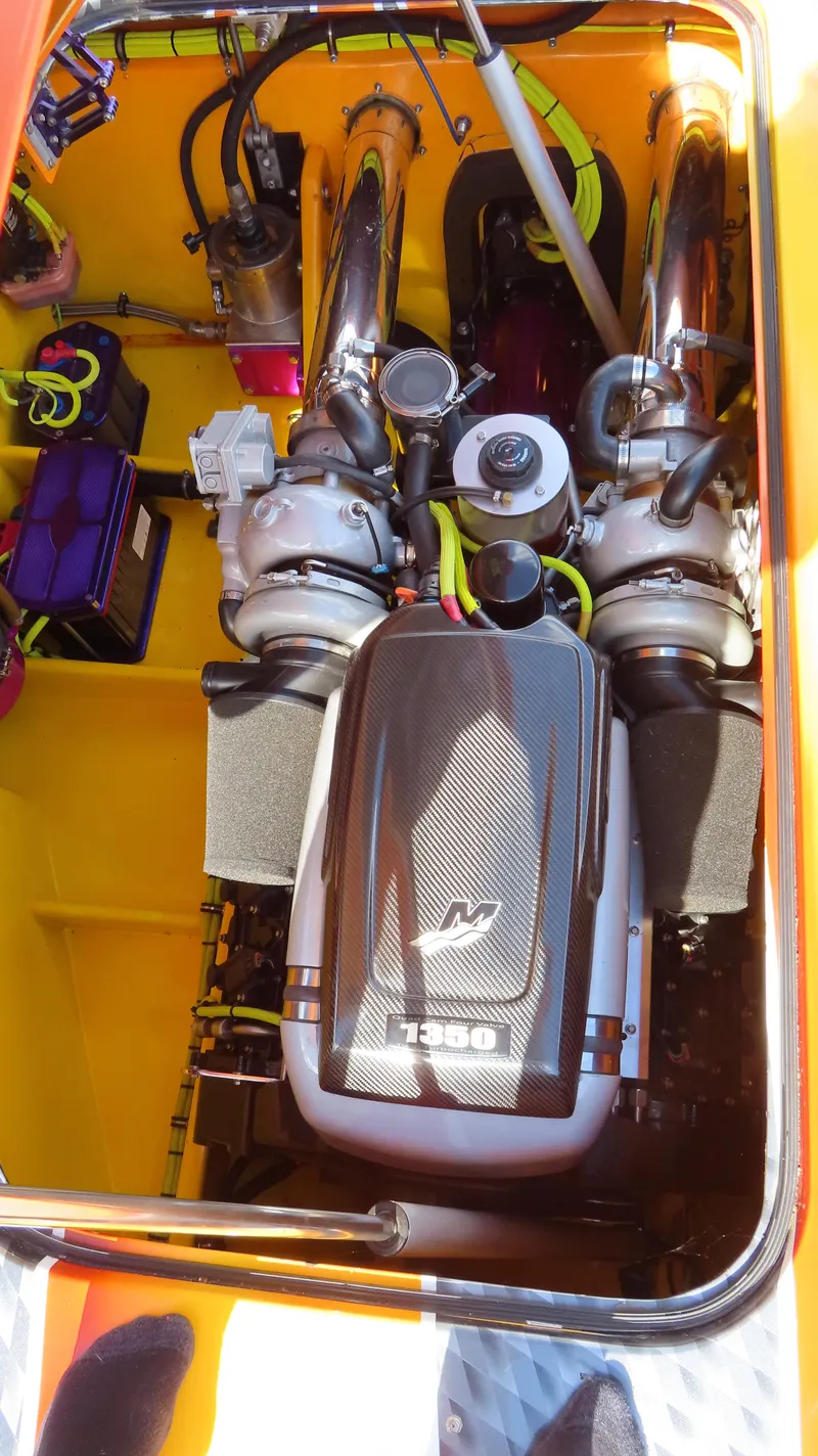 Slide: The Image of High-performance engine of a 2010 MTI 48 R/P boat, showcasing intricate mechanical components. - 22