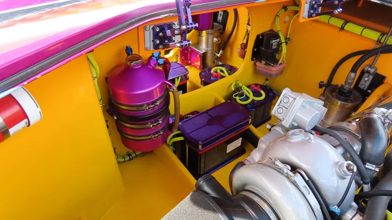 Slide: The Image of Engine compartment of a 2010 MTI 48 R/P boat, featuring vibrant components and advanced machinery. - 23