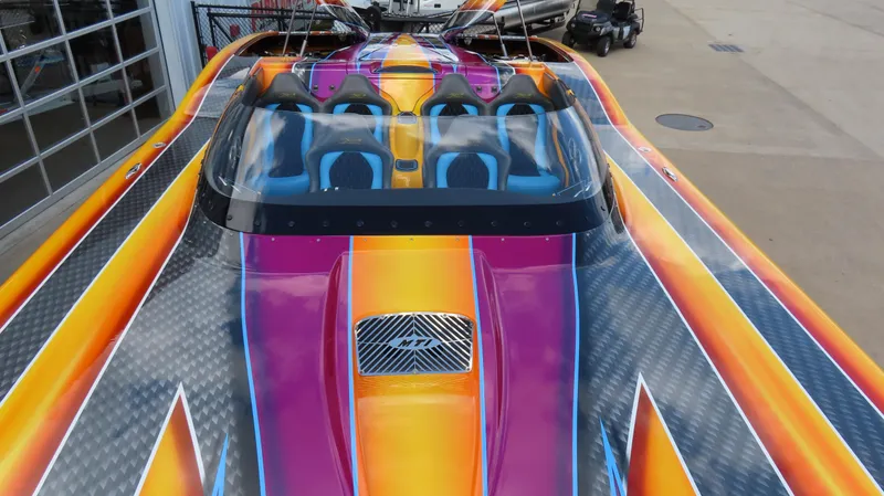 Slide: The Image of Vibrant 2010 MTI 48 R/P speedboat with colorful, dynamic design and sleek seating arrangement. - 27