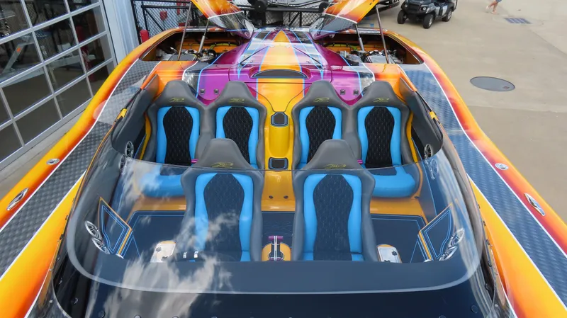 Slide: The Image of Vibrant 2010 MTI 48 R/P speedboat with colorful seating and sleek design. - 28