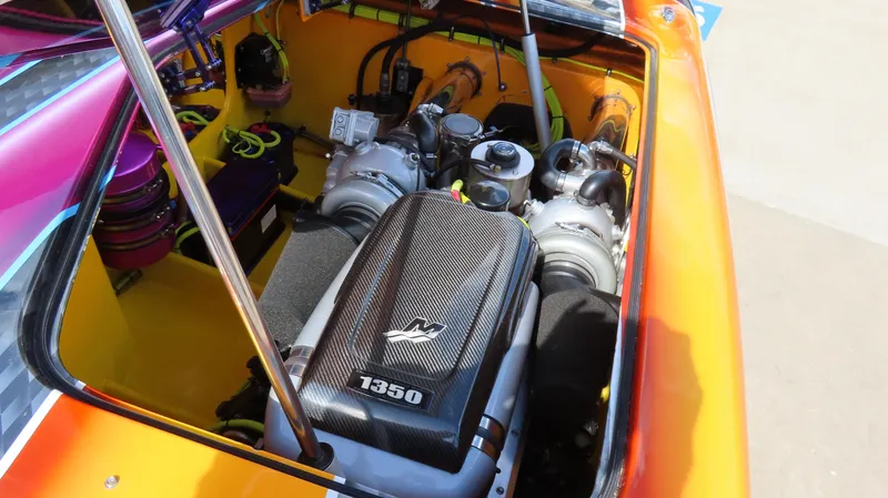 Slide: The Image of Engine compartment of a 2010 MTI 48 R/P boat with vibrant colors and powerful motor. - 3