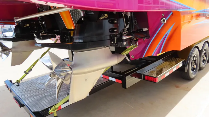 Slide: The Image of Rear view of a 2010 MTI 48 R/P boat with vibrant colors and dual propellers. - 33