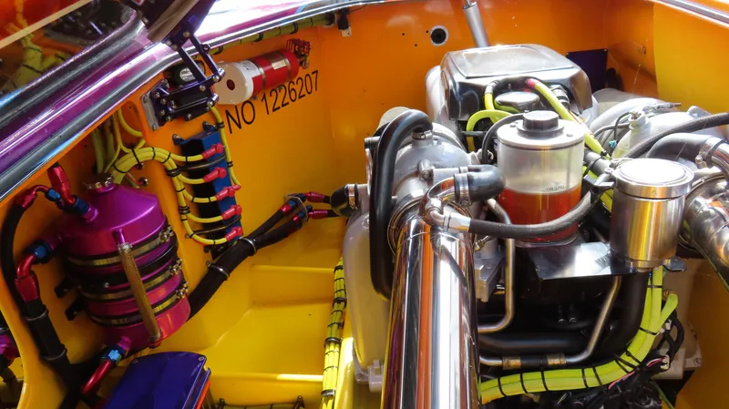 Slide: The Image of Engine compartment of a 2010 MTI 48 R/P boat, featuring colorful wiring and components. - 37