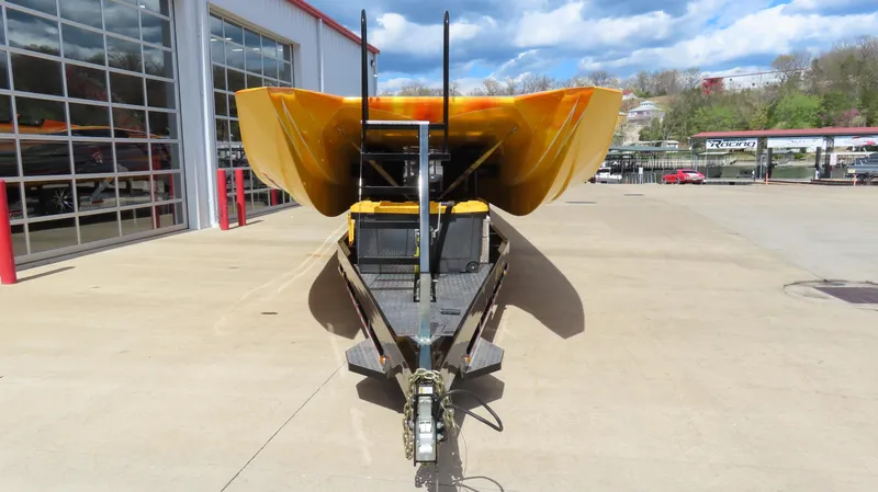 Slide: The Image of 2010 MTI 48 R/P boat on trailer, parked outside a garage under a partly cloudy sky. - 5
