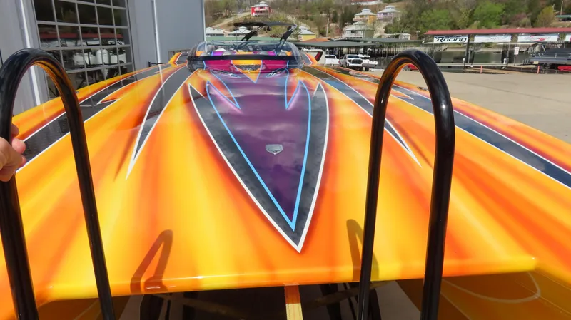 Slide: The Image of Vibrant orange MTI 48 R/P speedboat with striking purple and blue accents, 2010 model. - 6