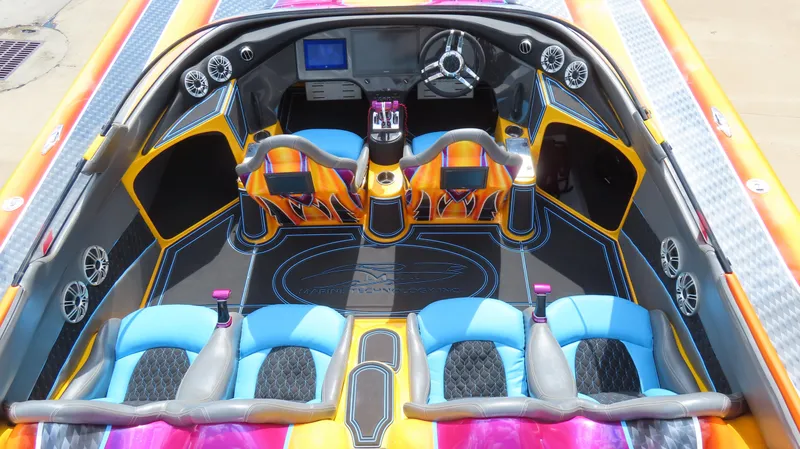 Slide: The Image of Vibrant interior of 2010 MTI 48 R/P boat with colorful seating and modern dashboard. - 8