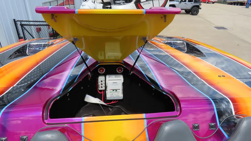 Slide: The Image of Vibrant 2010 MTI 48 R/P boat with open hatch, showcasing colorful design and interior details. - 9