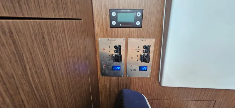 Slide: The Image of Control panel of 2022 Beneteau Antares 11 boat, featuring digital displays and switches. - 12