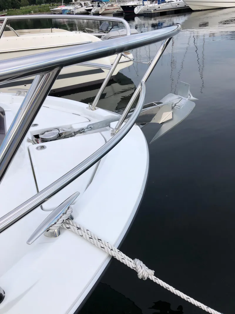 Slide: The Image of 2022 Beneteau Antares 11 boat docked, showcasing sleek bow design and stainless steel railings. - 5