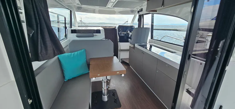 Slide: The Image of Interior of 2022 Beneteau Antares 11, featuring modern seating and helm, with ocean view. - 8