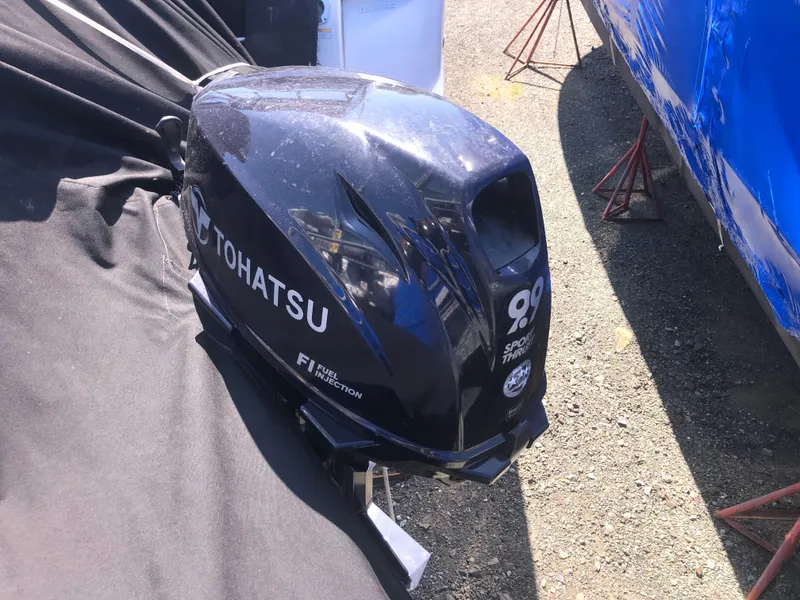 Slide: The Image of Tohatsu 90 horsepower outboard motor on display, next to a 2007 Cruisers Yachts 340 Express. - 10