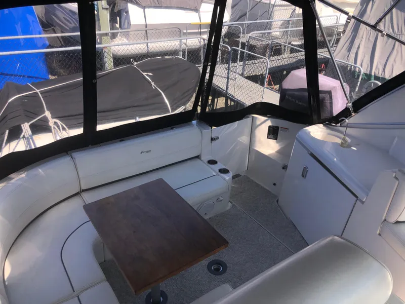 Slide: The Image of 2007 Cruisers Yachts 340 Express cockpit with seating, table, and covered area. - 13