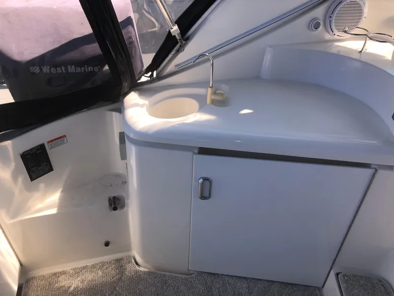 Slide: The Image of 2007 Cruisers Yachts 340 Express interior with sink and storage cabinet. - 14