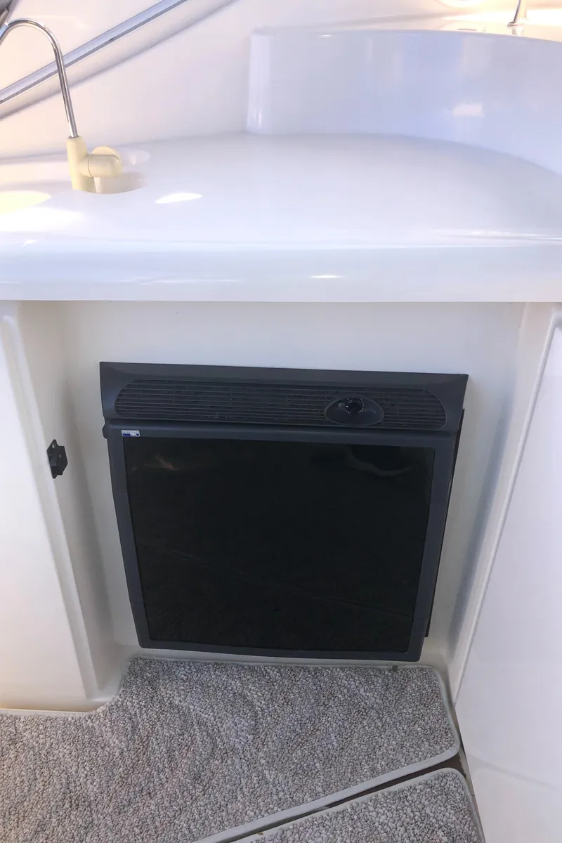 Slide: The Image of 2007 Cruisers Yachts 340 Express interior with built-in mini fridge. - 15