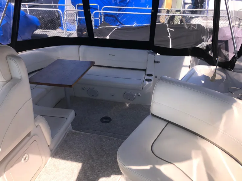 Slide: The Image of 2007 Cruisers Yachts 340 Express interior with seating and table, featuring beige upholstery. - 16