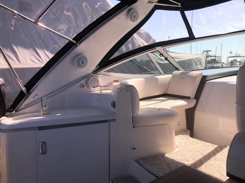 Slide: The Image of 2007 Cruisers Yachts 340 Express interior with seating and cabinetry, docked at marina. - 17