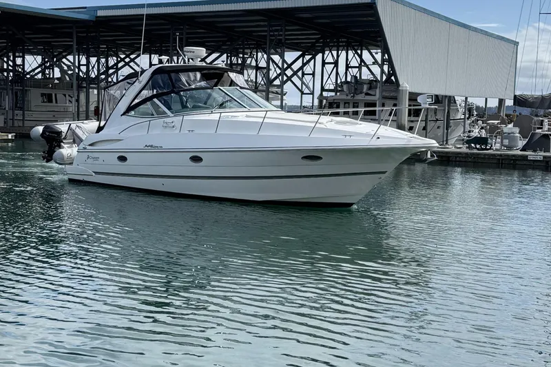 Slide: The Image of 2007 Cruisers Yachts 340 Express in marina, sleek design, calm water reflection. - 2