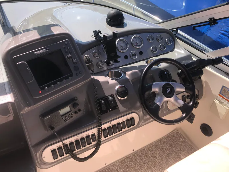 Slide: The Image of 2007 Cruisers Yachts 340 Express helm with steering wheel and navigation controls. - 20
