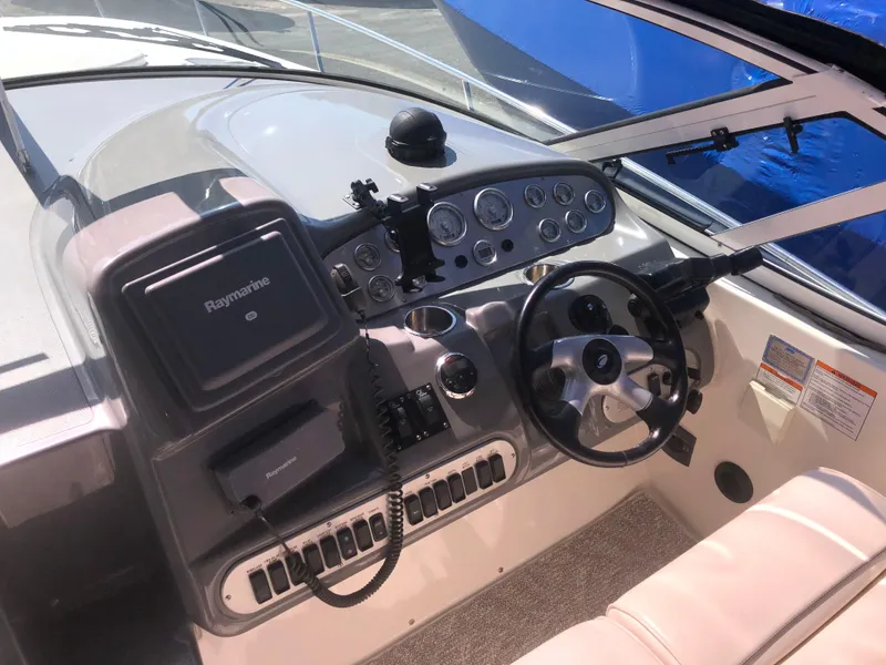 Slide: The Image of 2007 Cruisers Yachts 340 Express helm with steering wheel and navigation controls. - 21