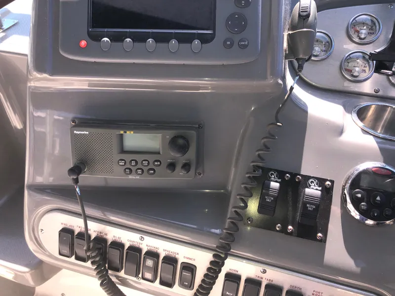 Slide: The Image of Control panel of 2007 Cruisers Yachts 340 Express with radio and switches. - 25