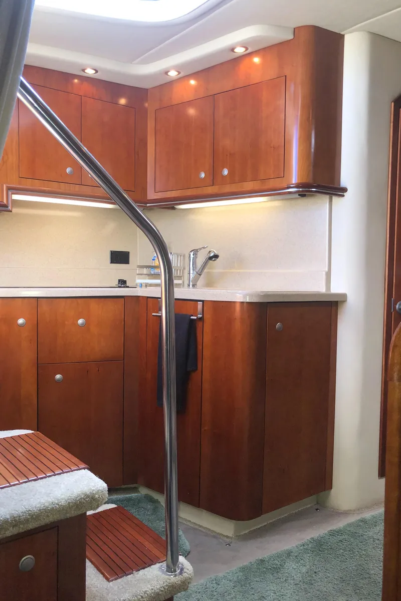 Slide: The Image of 2007 Cruisers Yachts 340 Express interior with wooden cabinetry and modern fixtures. - 27