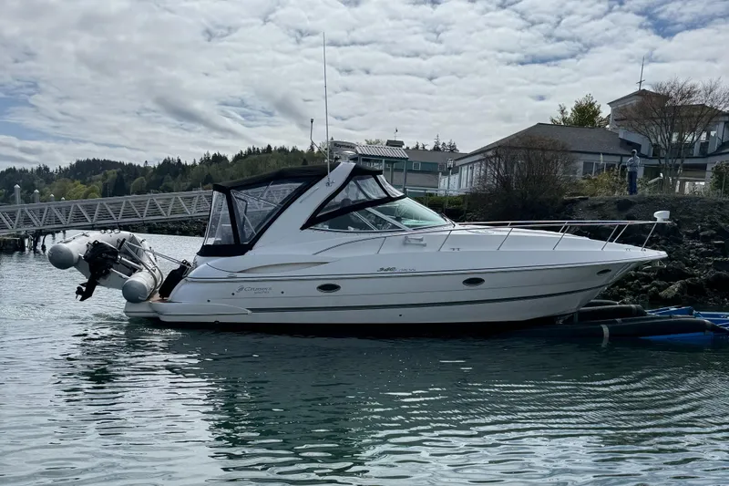 Slide: The Image of 2007 Cruisers Yachts 340 Express docked in a scenic marina setting. - 3