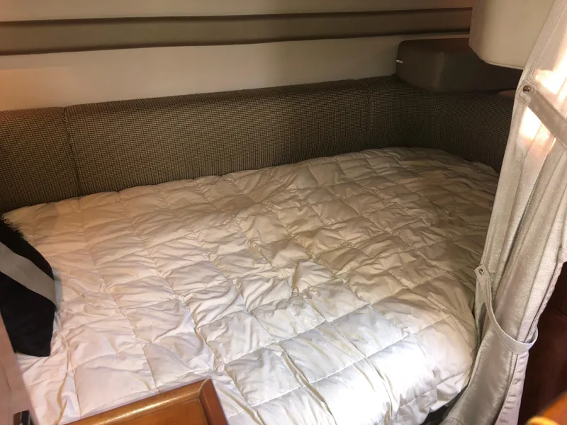 Slide: The Image of 2007 Cruisers Yachts 340 Express cabin with cozy bed and soft lighting. - 30